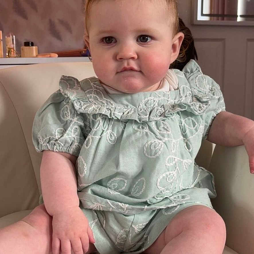 Nevaeh Rose is registered to the contest to win money with this photo: baby, chair, child, comfort, cute, embroidered_clothing, expressionless, face, furniture, head, indoor, mint_green, person, pigtails, plush, portrait, sitting, skin, sock, young_child