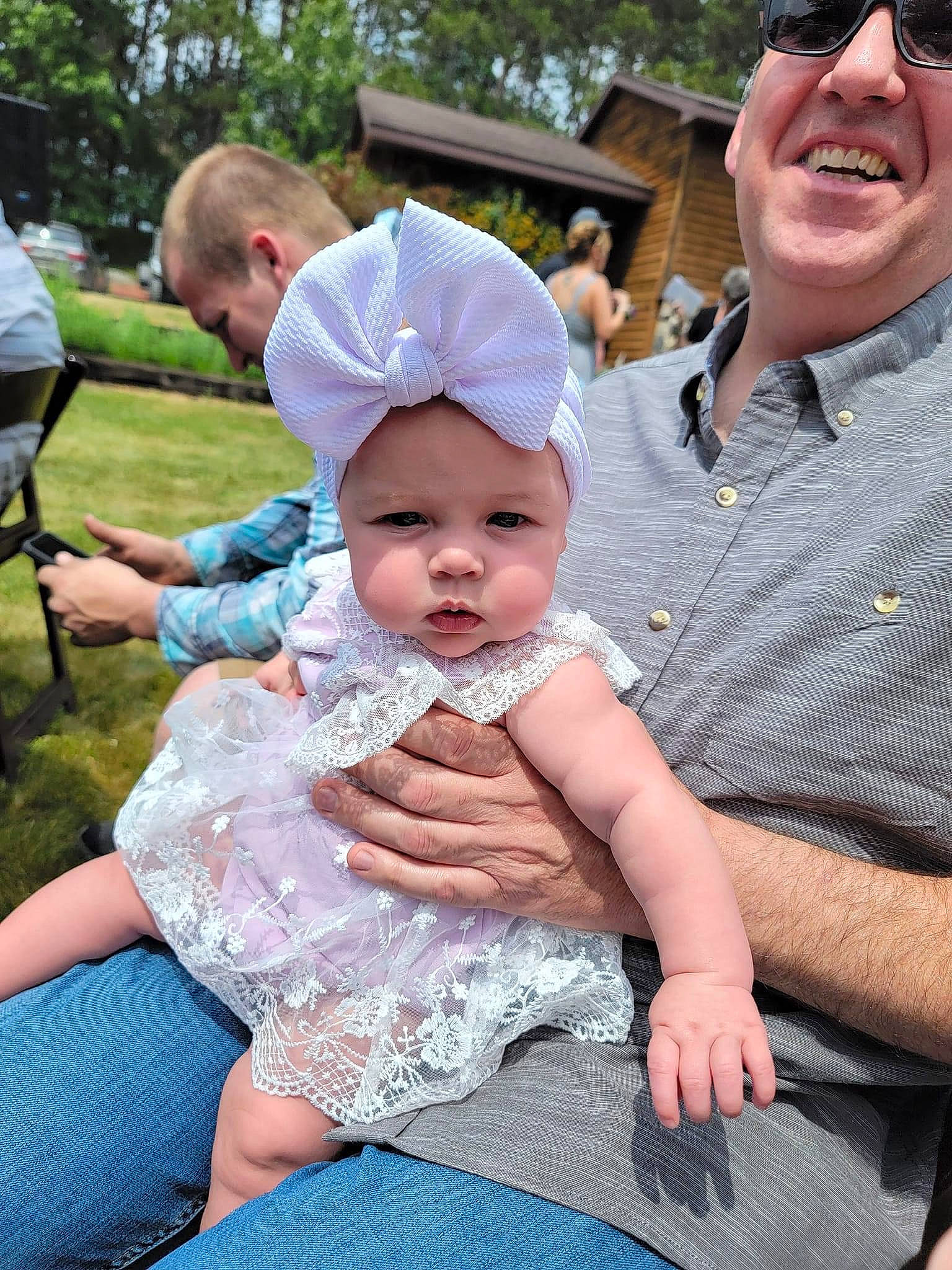 Caitlin is registered to the contest to win money with this photo: baby, baby_toddler_clothing, baseball_cap, cap, chair, child, event, fun, grass, happy, hat, head, headwear, person, pink, recreation, skin, smile, sun_hat, sunglasses