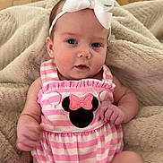 Carter Grace is registered to the contest to win money with this photo: baby, infant, headband, bow, pink_stripes, mickey_mouse, clothing, blanket, wooden_floor, cute, child, portrait, sitting, indoors, soft_texture, relaxed, young, small, person, adorable