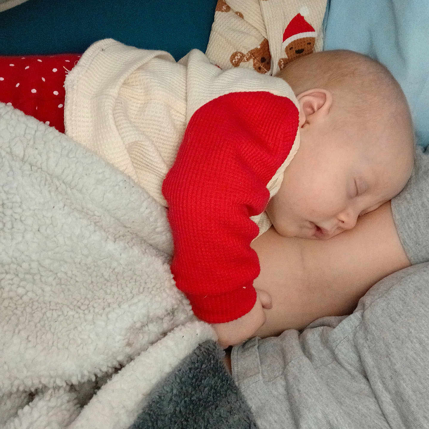 Ryleigh joined the competition — help win amazing prizes! adult, arm, baby, bedroom, blanket, cheek, closeup, cozy, cuddling, ear, face, fluffy_blanket, gray_shirt, home_interior, infant, pajamas, red_sleeve, resting, sleeping, white_sweater