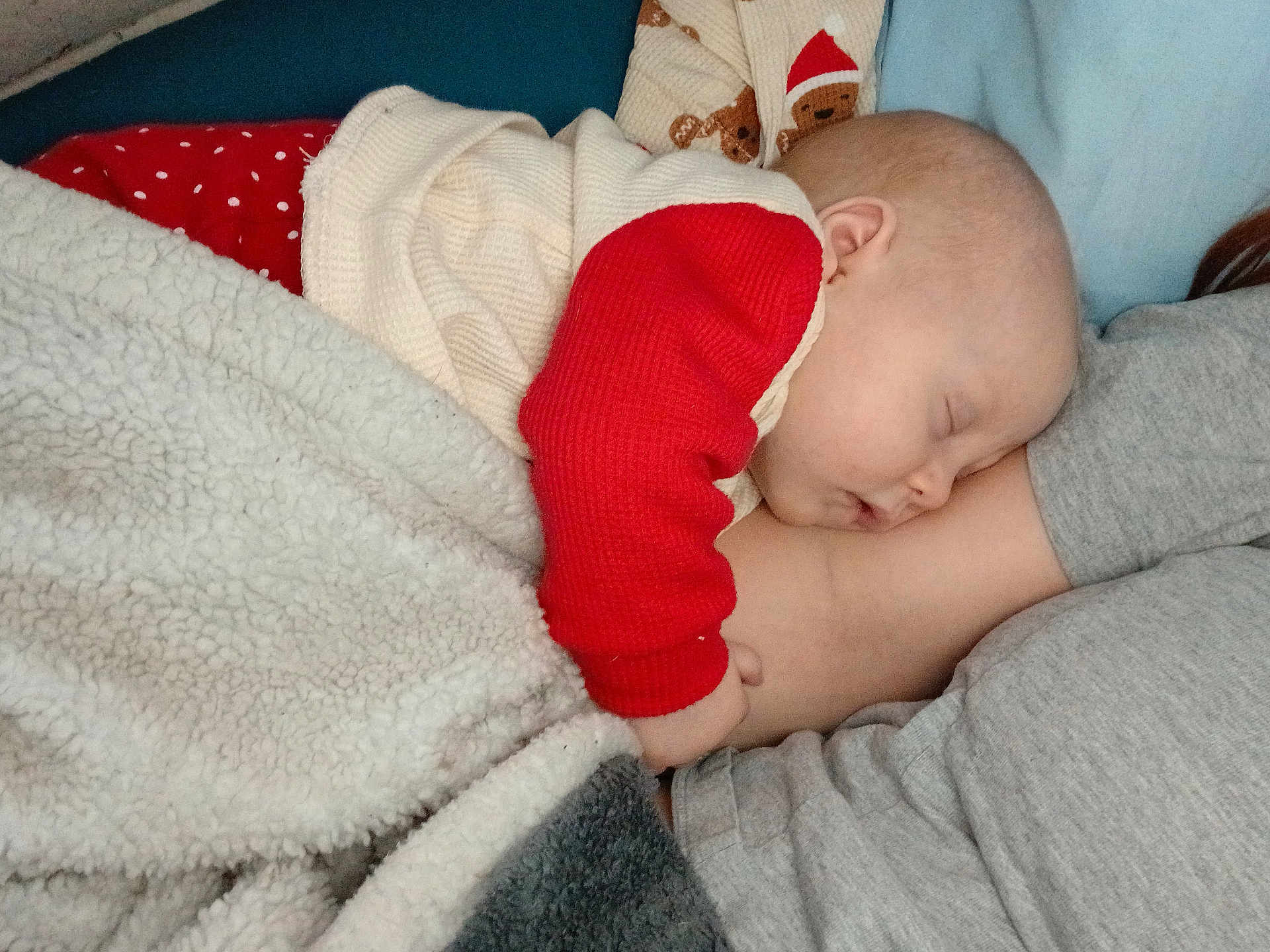 Ryleigh joined the competition — help win amazing prizes! baby, infant, sleeping, blanket, red_sleeve, white_sweater, fluffy_blanket, adult, arm, cheek, ear, face, resting, cuddling, bedroom, cozy, home_interior, pajamas, gray_shirt, closeup
