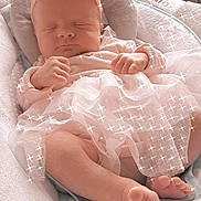 Annie Guinet participe au concours pour gagner de l'argent avec cette photo : baby, sleeping, infant, pink, headband, flower, cushion, blanket, soft, tulle, dress, peaceful, closeup, indoors, newborn, feet, hands, face, cute, sparkles