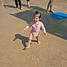 child, toddler, swimsuit, water_park, splash_pad, outdoor, sunny, water, playing, barefoot, summer, fun, kids, sprinkler, wet, recreation, playground, family, active, daytime
