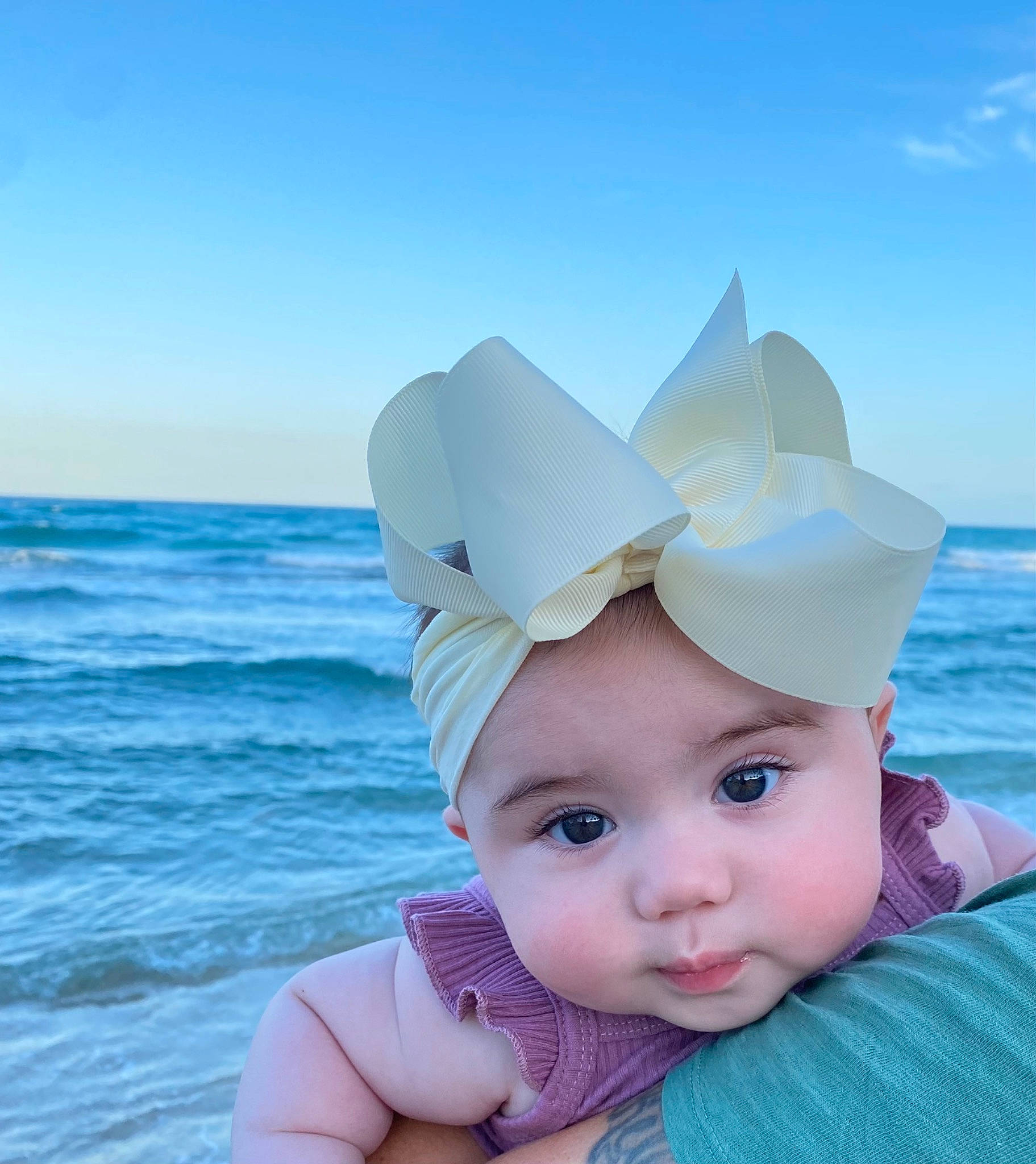 Liv is registered to the contest to win money with this photo: azure, baby_toddler_clothing, blue, body_of_water, cap, cloud, costume_hat, eye, fun, happy, hat, head, headgear, headwear, people_in_nature, person, pink, sky, sun_hat, toddler