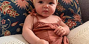Alma a rejoint le concours — aidez-le/la à gagner de superbes lots ! baby, bow, child, closeup, comfortable, couch, cute, decor, expression, fabric, headband, indoor, infant, pattern, person, pillow, plush, portrait, romper, sitting