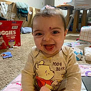 Khloe joined the competition — help win amazing prizes! baby, carpet, child, clothing, cute, diapers, happy, household_items, indoor, infant, messy_face, person, playmat, pooh_bear, real_photo, room, sitting, smiling, toy, young_child
