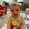 baby, carpet, child, clothing, cute, diapers, happy, household_items, indoor, infant, messy_face, person, playmat, pooh_bear, real_photo, room, sitting, smiling, toy, young_child