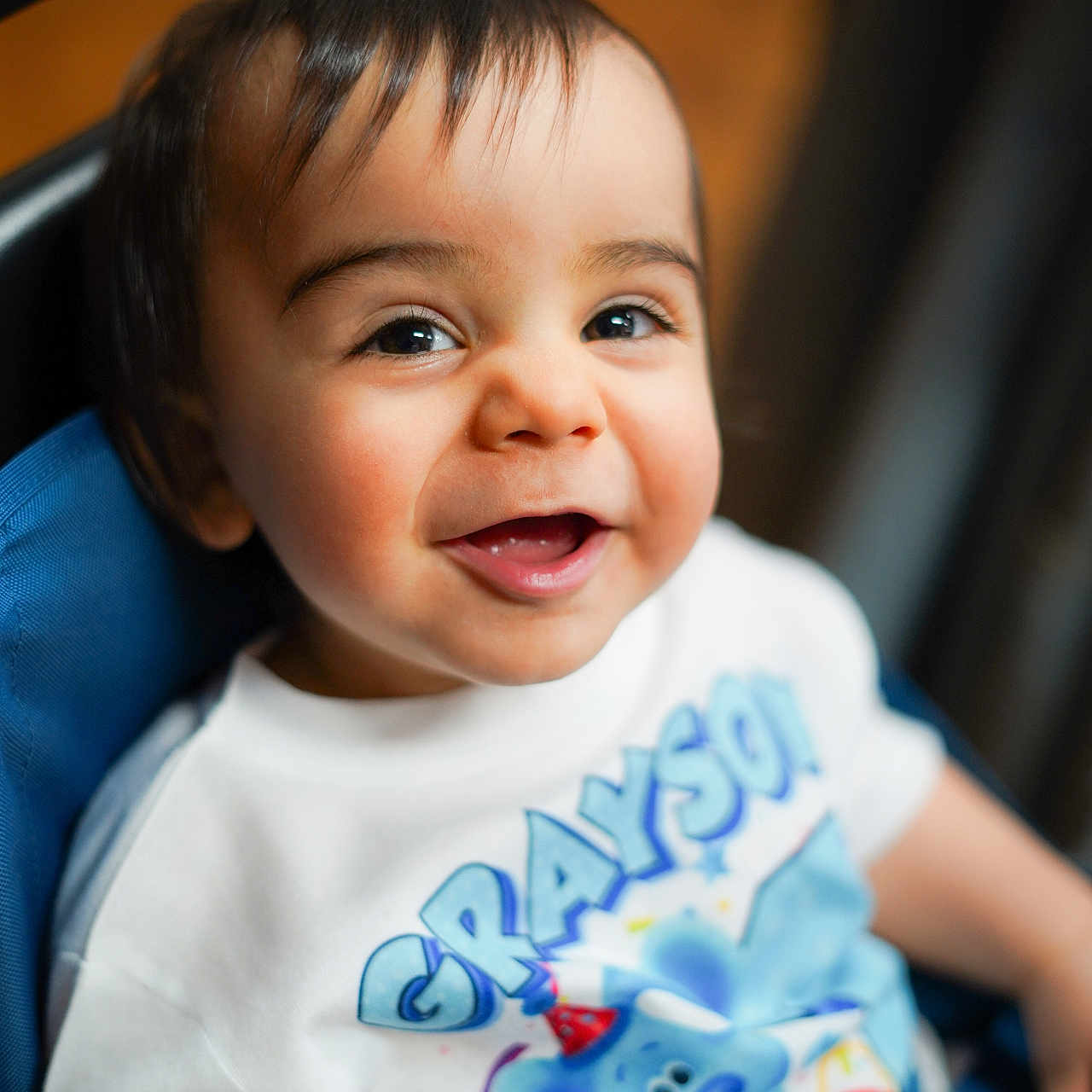 Grayson is registered to the contest to win money with this photo: baby, babylaughing, bodypart, clothing, face, finger, hand, happy, head, laughing, mouth, newborn, person, photography, portrait, shirt, smile, stroller, t_shirt, teeth
