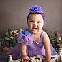Maddie is registered to the contest to win money with this photo: baby, child, girl, smiling, purple_dress, headband, flower, tulle, chair, rustic, flowers, decor, portrait, happy, indoor, cute, infant, closeup, person, fashion
