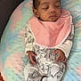 baby, sleeping, infant, onesie, bib, pastel_colors, cushion, blanket, animal_print, hand, peaceful, resting, soft_texture, cozy, indoor, child, portrait, cute, relaxation, young