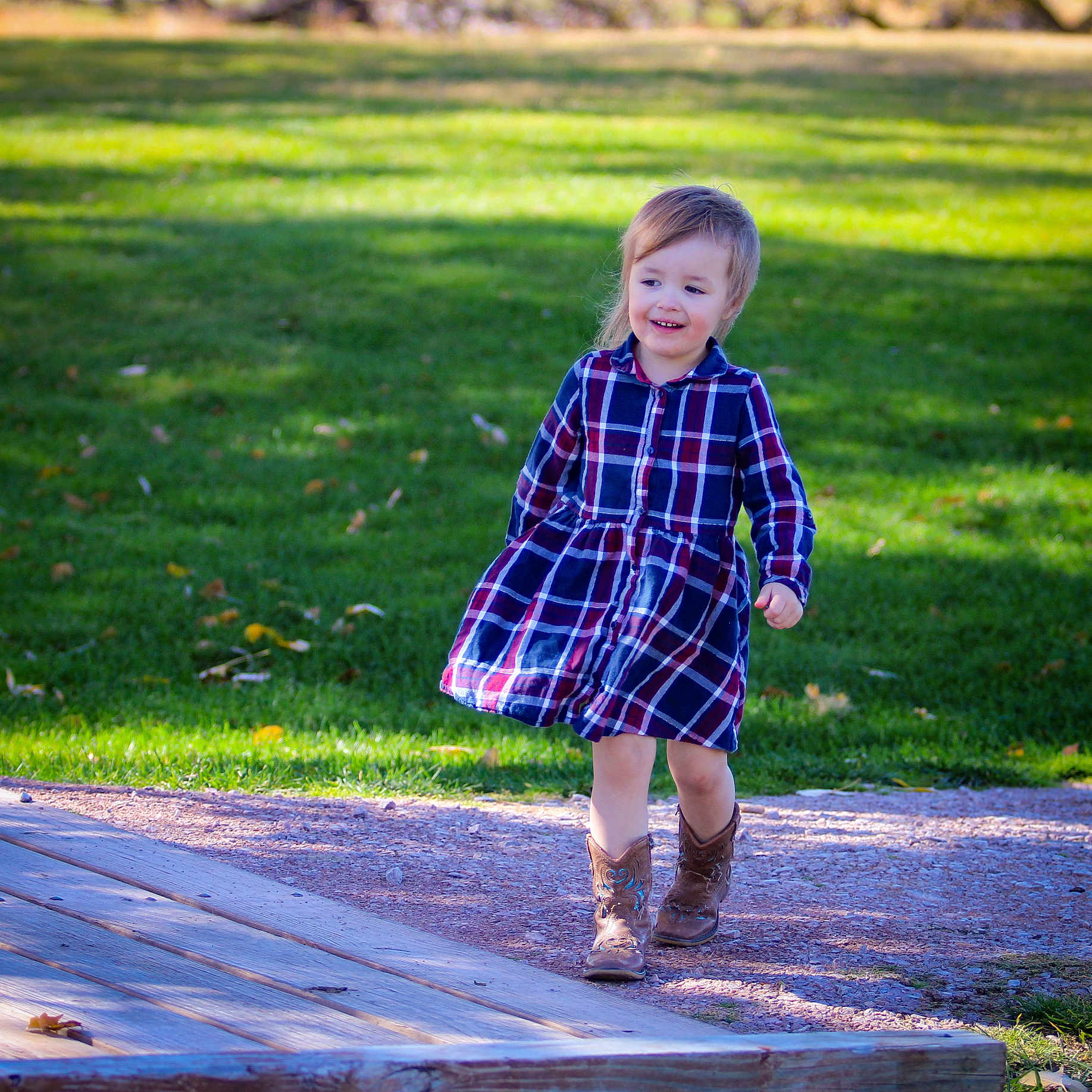 Jupiter is registered to the contest to win money with this photo: boot, child, clothing, coat, dress, face, fashion, female, footwear, girl, grass, head, lawn, person, photography, plant, portrait, shoe, tartan, tree