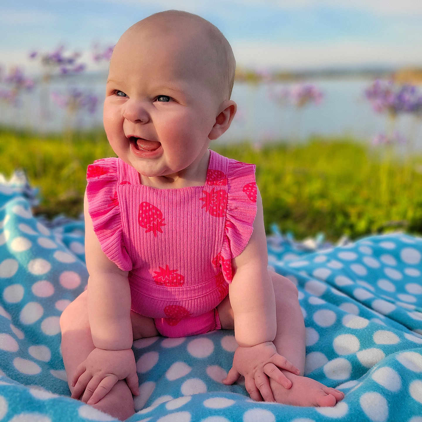 Peyton is registered to the contest to win money with this photo: baby, babylaughing, blanket, clothing, dress, face, flower, grass, happy, head, laughing, newborn, person, photography, plant, portrait, purple, quilt, sitting, smile