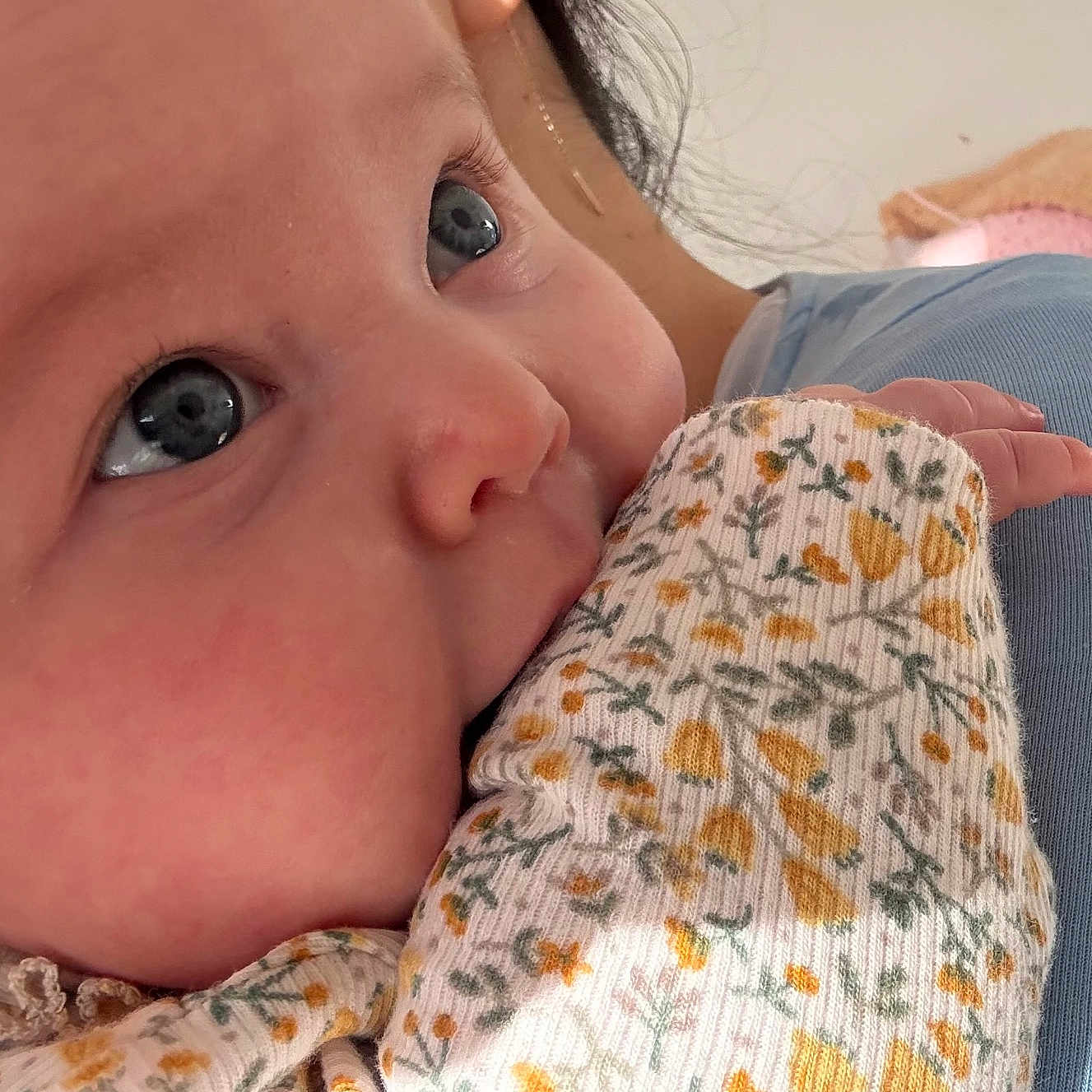 Ilinca joined the competition — help win amazing prizes! baby, blue_eyes, child, close_up, clothing, cozy, cute, expression, eyelashes, face, floral_pattern, hand, human, infant, person, portrait, skin, sleeve, soft_light, warm