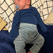 James joined the competition — help win amazing prizes! baby, pacifier, striped_pants, blue_top, blanket, sleeping, infant, child, soft_fabric, bed, comfort, resting, cute, newborn, skin, face, foot, clothing, indoors, lying_down