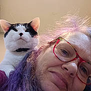 Biscuit joined the competition — help win amazing prizes! woman, cat, glasses, purple_hair, indoor, portrait, pet, shoulder, smile, face, closeup, whiskers, black_and_white_cat, human, hair, eyewear, cute, animal, indoor_lighting, playful