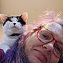 woman, cat, glasses, purple_hair, indoor, portrait, pet, shoulder, smile, face, closeup, whiskers, black_and_white_cat, human, hair, eyewear, cute, animal, indoor_lighting, playful
