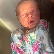 Vienna Bobby Les is registered to the contest to win money with this photo: newborn, baby, sleeping, infant, floral, onesie, clothing, soft_light, closeup, portrait, peaceful, child, human, cute, indoors, person, small, face, head, skin