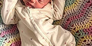 Vienna Bobby Les is registered to the contest to win money with this photo: newborn, baby, sleeping, onesie, heart_pattern, crocheted_blanket, colorful, infant, peaceful, cozy, soft, cute, child, portrait, indoors, resting, young, toddler, sleep, fabric
