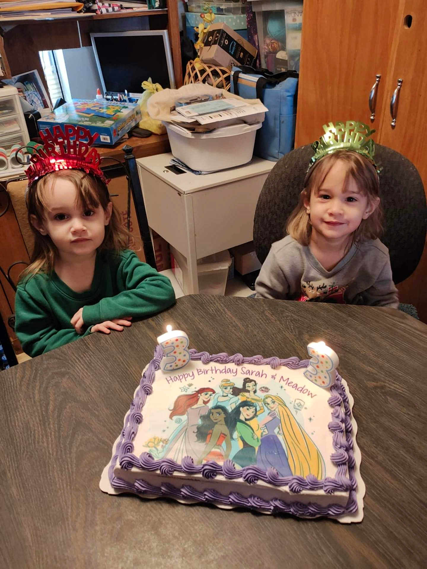 Sarah And Meadow is registered to the contest to win money with this photo: child, birthday_cake, birthday_candles, birthday_crowns, table, room, cake, princesses, smile, celebration, happy, party, indoor, furniture, person, young_children, candles, clothing, hair, face