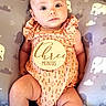 Illyana is registered to the contest to win money with this photo: baby, infant, child, onesie, peach_color, milestone, wooden_sign, three_months, pillow, elephant_pattern, cushion, cute, portrait, lying_down, skin, face, arms, legs, indoor, calm