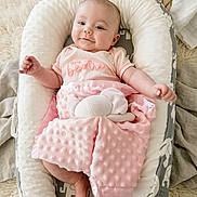 Illyana joined the competition — help win amazing prizes! baby, infant, smiling, blanket, plush_toy, baby_nest, pink, soft_texture, cute, child, happy, comfortable, clothing, indoor, portrait, baby_girl, resting, cozy, home, newborn