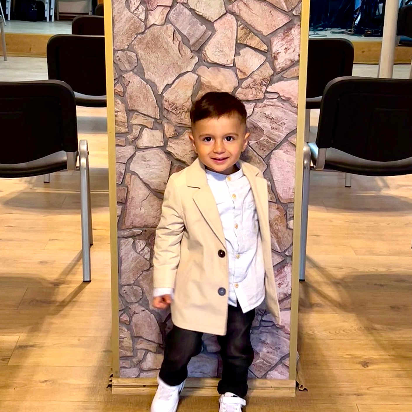 Ezra is registered to the contest to win money with this photo: boy, chair, child, clothing, coat, face, footwear, furniture, head, indoors, interiordesign, jacket, male, overcoat, pants, person, photography, portrait, shoe, wood