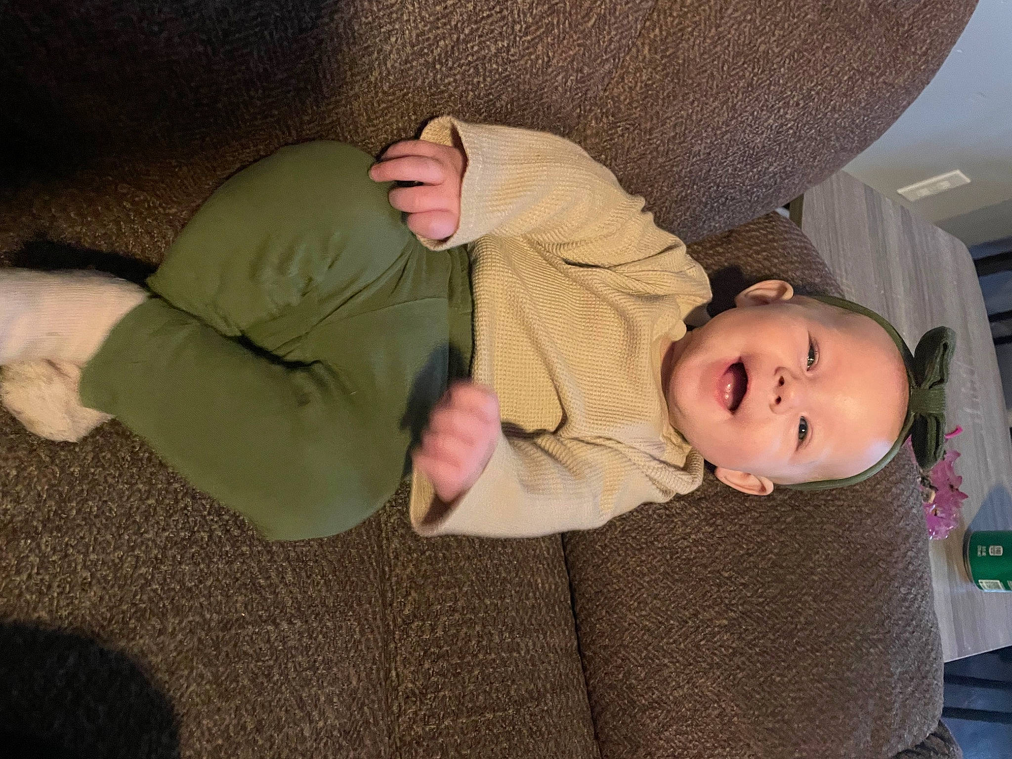 Harper is registered to the contest to win money with this photo: baby, baby_toddler_clothing, cheek, child, comfort, elbow, facial_expression, finger, gesture, hat, human_body, human_leg, knee, leg, person, room, sitting, skin, sleeve, toddler