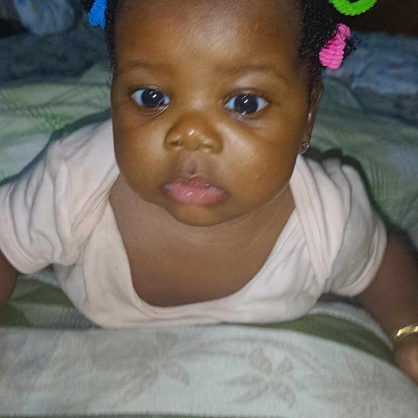 Toniann is registered to the contest to win money with this photo: accessories, baby, bed, bedroom, crawling, cushion, earring, face, furniture, happy, head, homedecor, indoors, jewelry, person, photography, portrait, quilt, room, smile