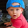 toddler, child, blue_cap, red_shirt, crawling, indoor, curious, face, wide_eyes, young_child, baby, person, headwear, expression, candid, casual_clothing, floor, cute, portrait, infant