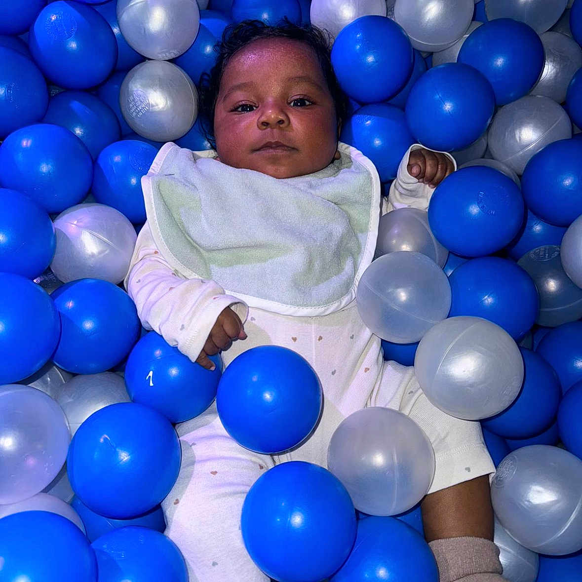 Zeni-Rain joined the competition — help win amazing prizes! baby, ball_pit, bib, blue_ball, child, childhood, clothing, cute, face, indoor, infant, lying_down, person, play, recreation, relaxing, socks, soft_lighting, toy, translucent_ball