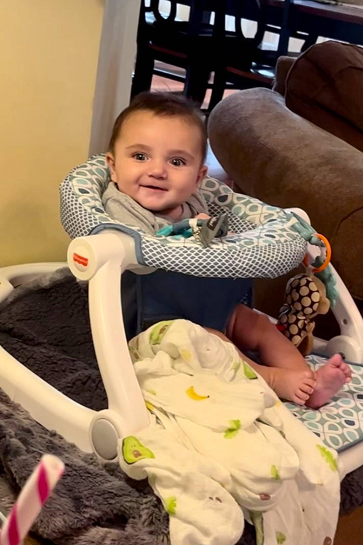 Kayson is registered to the contest to win money with this photo: baby, baby_carriage, baby_products, baby_toddler_clothing, chair, cheek, child, comfort, event, face, fun, happy, head, joy, lap, person, room, sitting, skin, smile