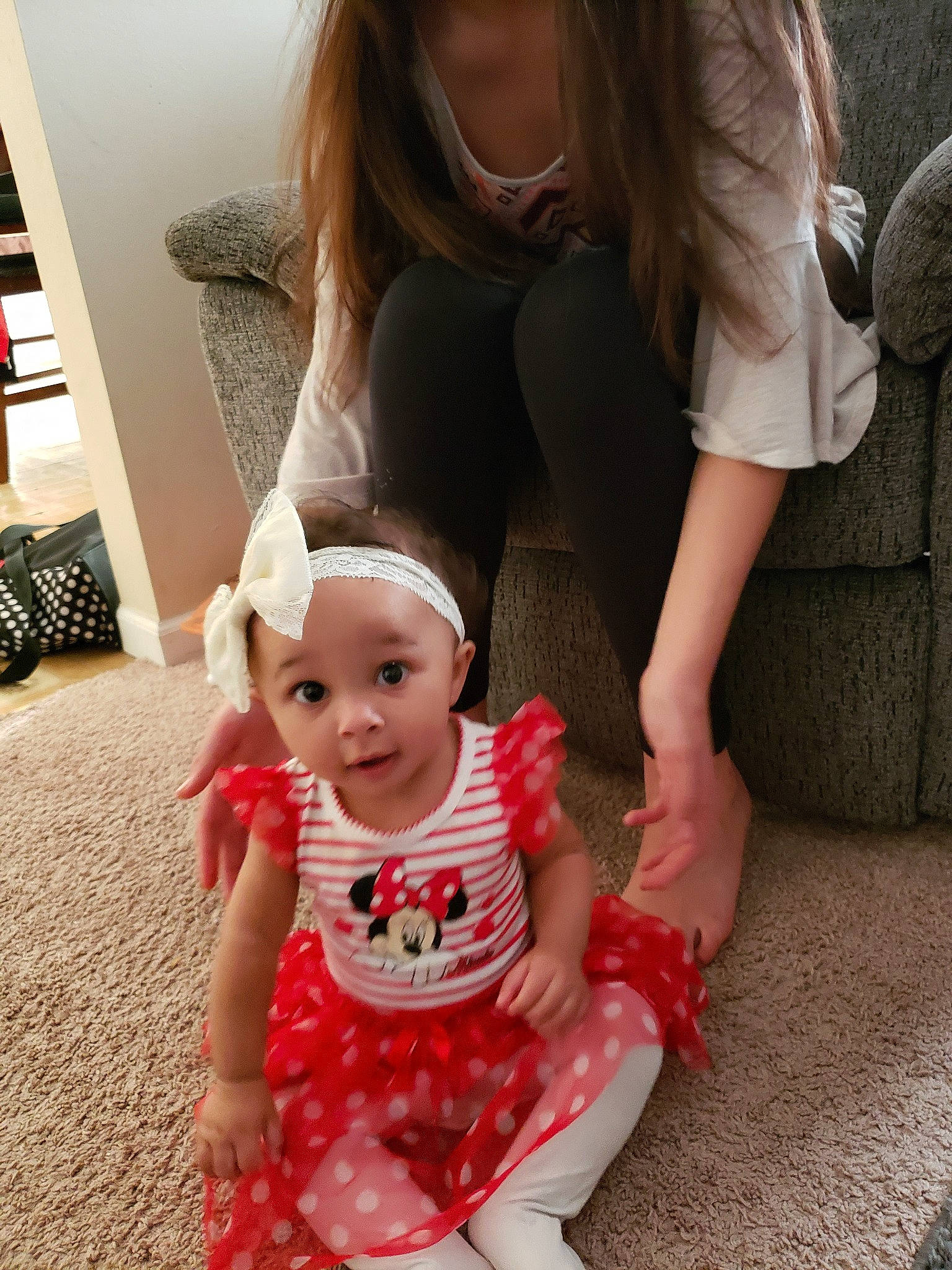 Kali is registered to the contest to win money with this photo: baby, child, daughter, dress, family, floor, flooring, fun, leg, mother, people, person, play, sitting, skin, smile, surprise, toddler