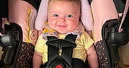 Luciana is registered to the contest to win money with this photo: baby, car_seat, child, smile, safety_harness, yellow_clothing, infant, cute, happy, seatbelt, pink, black, pattern, indoors, portrait, toddler, head_support, bright_eyes, sitting, person
