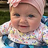 baby, child, face, smile, headband, flower, blue_eyes, floral_shirt, baby_seat, outdoor, closeup, cute, happy, infant, portrait, person, seat, colorful, soft_lighting, skin