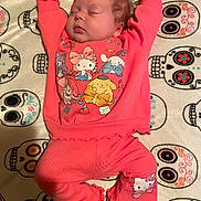 Luciana is registered to the contest to win money with this photo: baby, sleeping, pajamas, pink_clothing, cartoon_characters, blanket, sugar_skulls, pattern, infant, cute, relaxed, indoors, child, face, feet, hands, soft_texture, resting, cozy, colorful