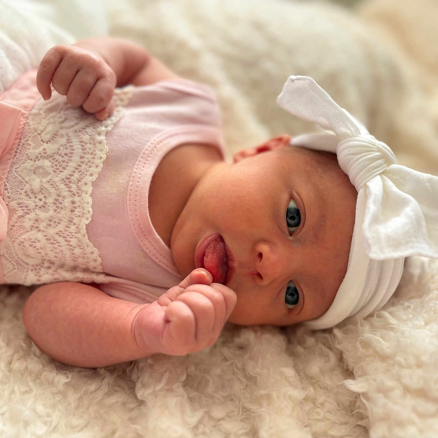 Hailie joined the competition — help win amazing prizes! baby, babylaughing, blanket, bodypart, bonnet, clothing, dress, face, finger, glove, hand, happy, hat, head, mouth, newborn, person, photography, portrait, smile