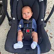 Owen joined the competition — help win amazing prizes! baby, infant, car_seat, stroller, harness, buckle, socks, pacifier, pacifier_clip, blue_eyes, newborn, concrete, leaves, outdoor, portrait, seat, clothing, headrest, black_fabric, carseat_handle