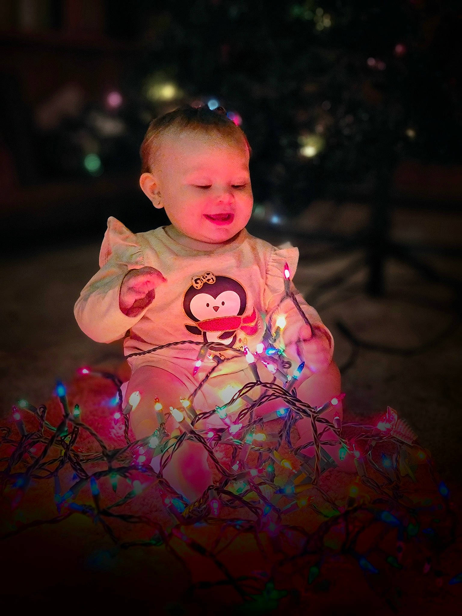 Raina is registered to the contest to win money with this photo: art, cheek, child, darkness, event, facial_expression, flash_photography, fun, grass, happy, head, leaf, magenta, person, pink, plant, purple, sitting, smile, tints_and_shades