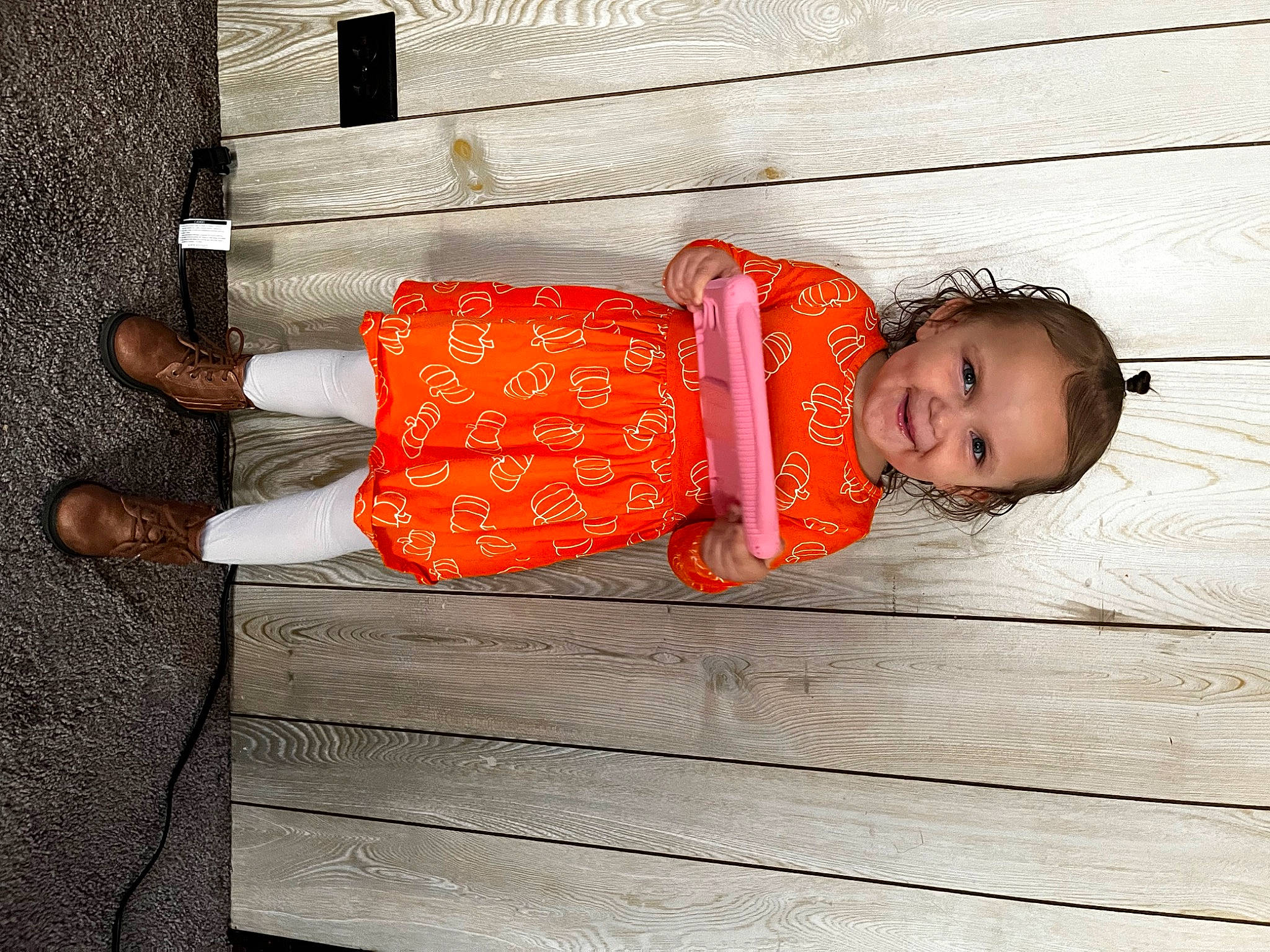 Lilyana joined the competition — help win amazing prizes! baby_toddler_clothing, child, comfort, fashion_accessory, flooring, hardwood, hat, human_leg, joy, orange, pattern, peach, person, red, sitting, sleeve, thigh, tints_and_shades, toddler, tree