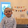 Maël a rejoint le concours — aidez-le/la à gagner de superbes lots ! toddler, child, birthday, indoor, celebration, banner, smiling, face, sweater, hand, chair, room, window, balloon, background, happy, cute, portrait, young, person