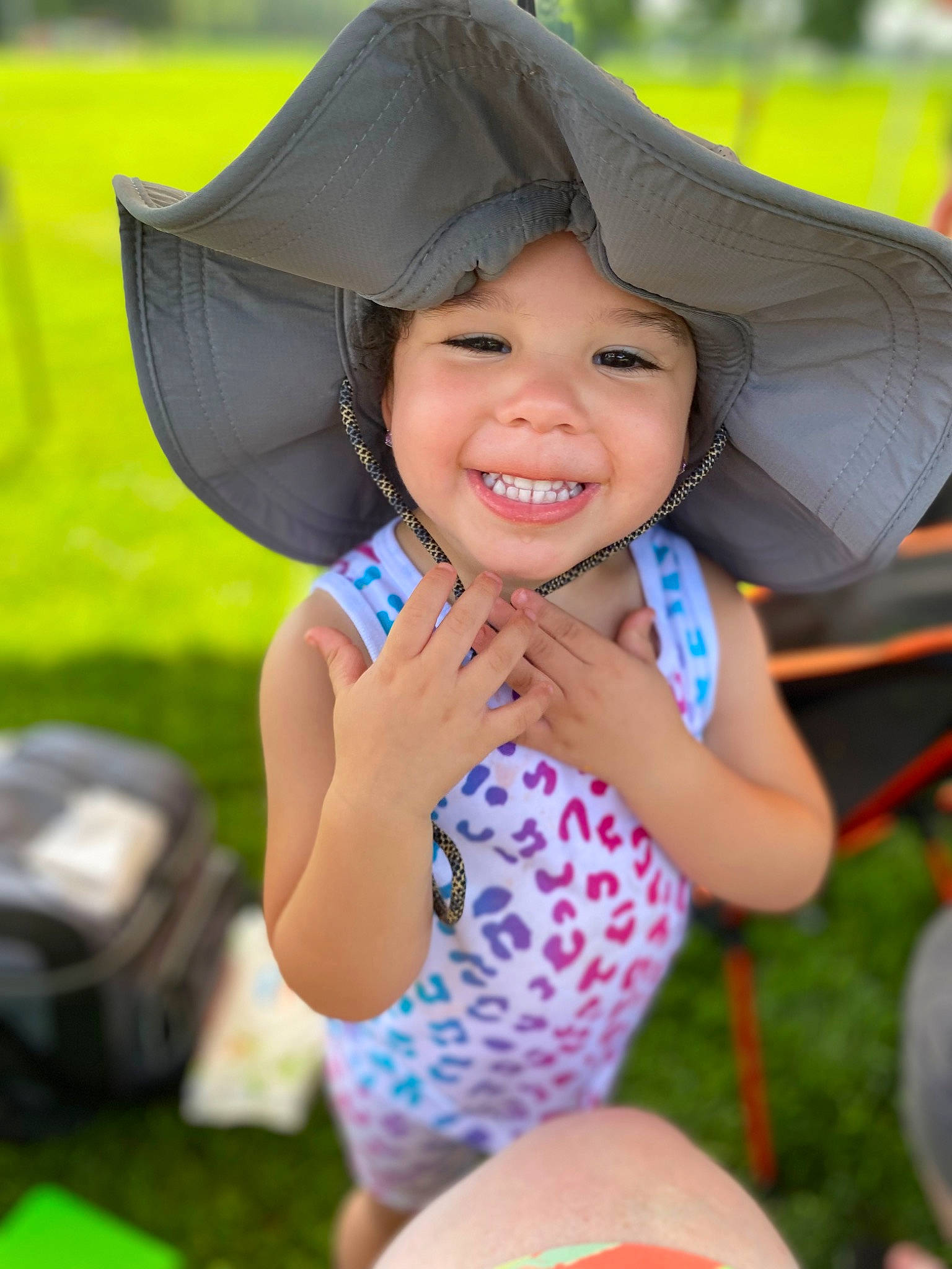 Natilee is registered to the contest to win money with this photo: ball, child, cool, electric_blue, fun, grass, happy, hat, headgear, headwear, joy, leisure, light, people_in_nature, person, personal_protective_equipment, recreation, smile, summer, sun_hat