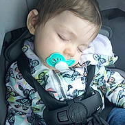 Harmony is registered to the contest to win money with this photo: child, toddler, sleeping, car_seat, car_safety, pacifier, butterfly_pattern, jacket, clothing, seatbelt, infant, baby, cute, peaceful, resting, transportation, seat, straps, head, portrait