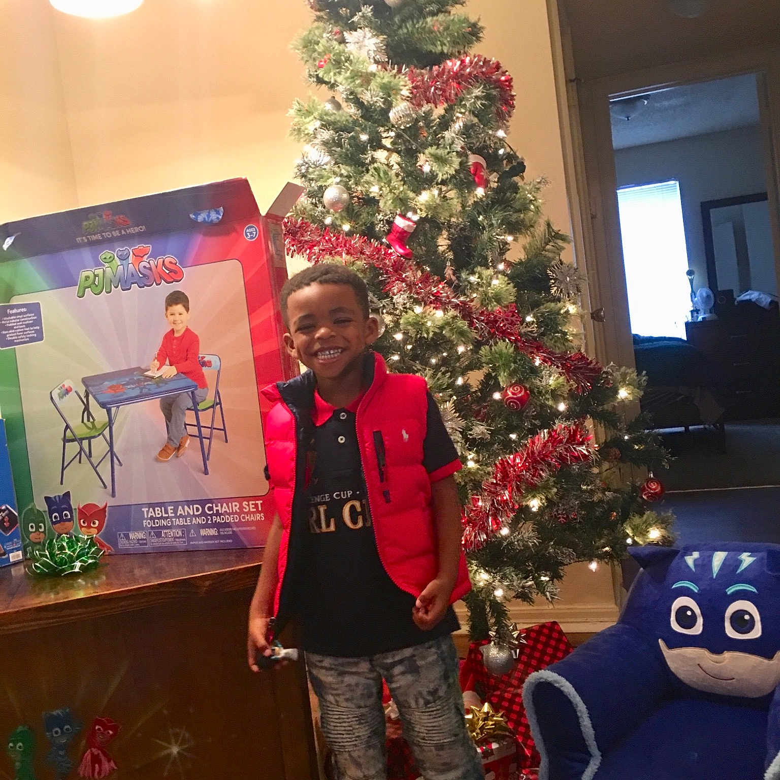 Jabari joined the competition — help win amazing prizes! christmas, christmas_decoration, christmas_eve, christmas_ornament, christmas_tree, conifer, event, fir, holiday, holiday_ornament, home, interior_design, joy, person, pine_family, plant, red, room, tree, woody_plant