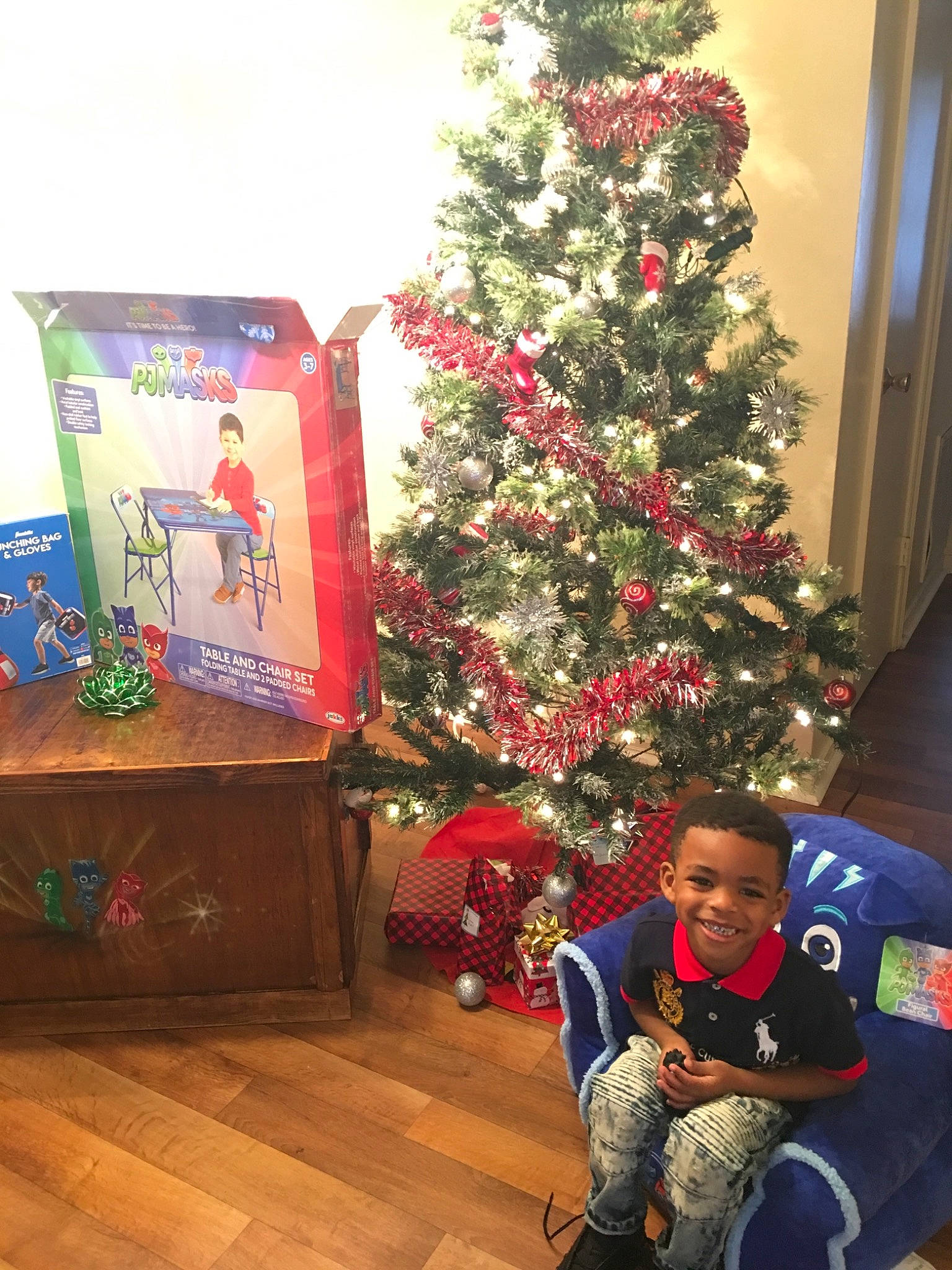 Jabari is registered to the contest to win money with this photo: christmas, christmas_decoration, christmas_eve, christmas_ornament, christmas_tree, colorado_spruce, conifer, event, fir, holiday, holiday_ornament, houseplant, interior_design, joy, person, pine_family, plant, tree, woody_plant