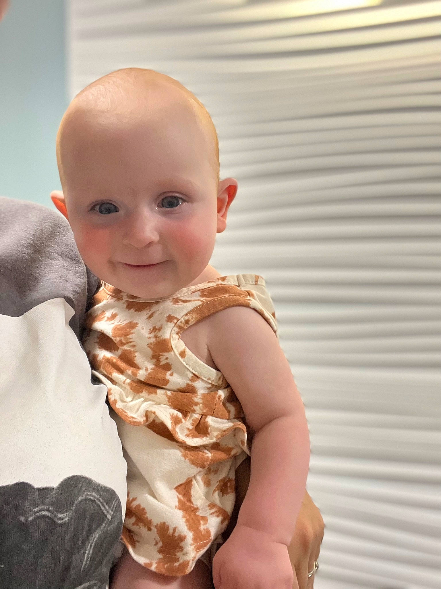 Mollie is registered to the contest to win money with this photo: arm, baby, baby_toddler_clothing, cheek, child, chin, comfort, elbow, happy, human_body, infant_bodysuit, joy, neck, pattern, person, skin, sleeve, smile, stomach, thumb