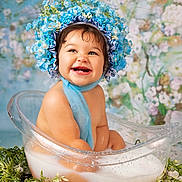 Alena joined the competition — help win amazing prizes! baby, child, smiling, flower_crown, blue_bonnet, milky_bath, clear_tub, water, greenery, floral_background, cute, happy, portrait, infant, sitting, skin, scarf, nature, innocence, studio_photo