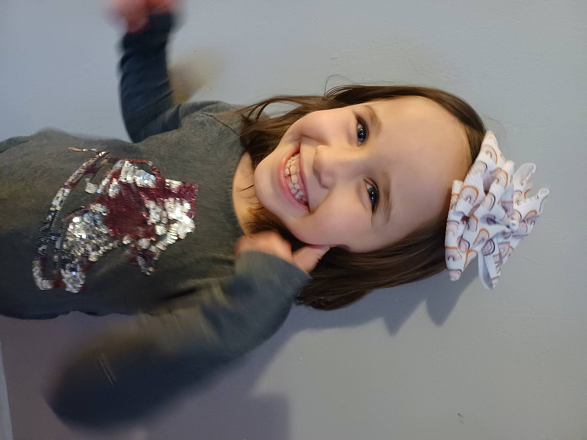 Jocelyn is registered to the contest to win money with this photo: brown_hair, dress, event, eye, eyelash, face, flash_photography, fun, gesture, happy, head, headwear, human_body, joy, lip, long_hair, outerwear, person, shoulder, skin