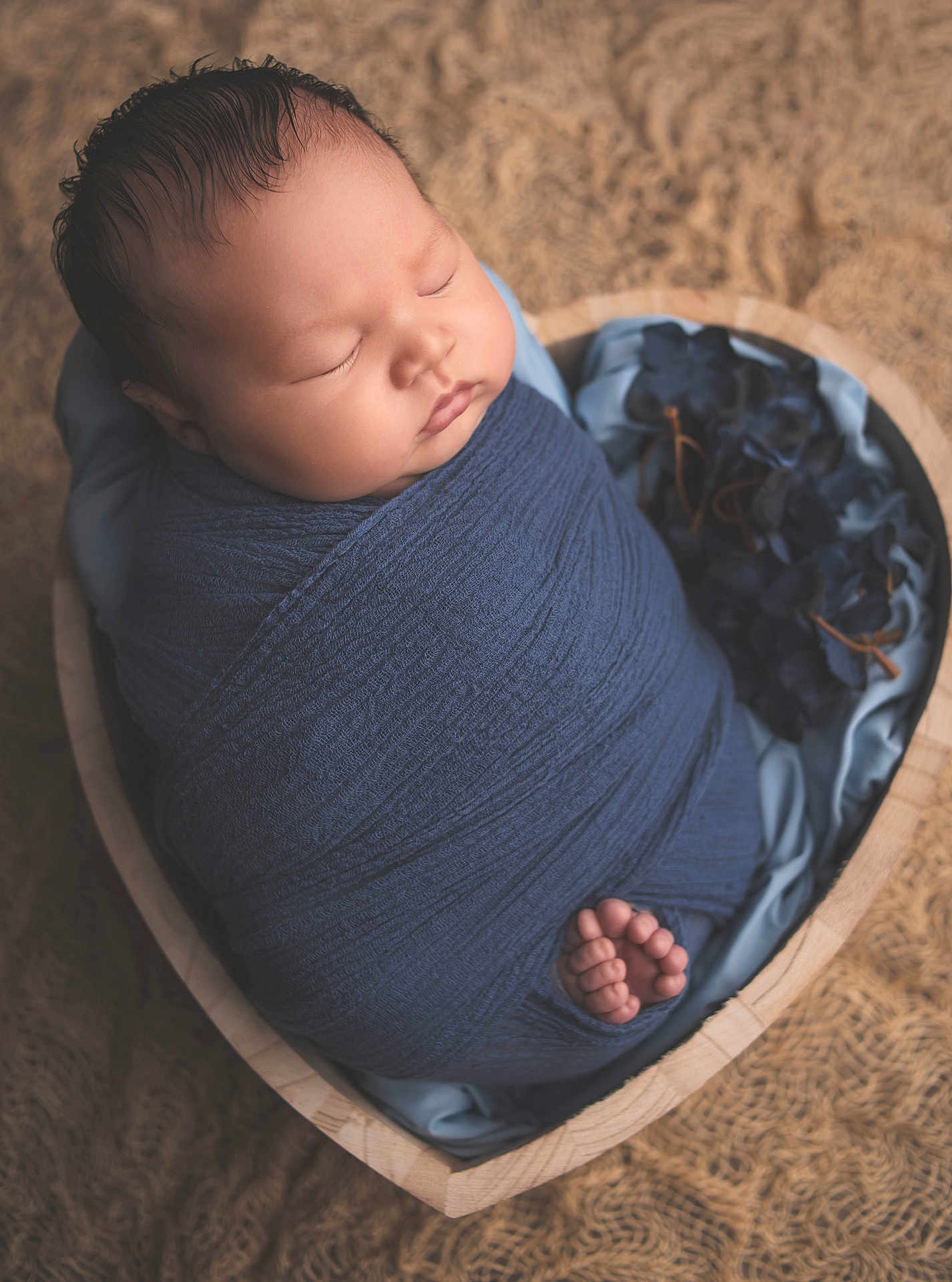Matt is registered to the contest to win money with this photo: newborn, baby, sleeping, swaddled, blue_cloth, heart_shaped_bowl, wooden_bowl, soft_fabric, flowers, peaceful, cute, infant, portrait, closeup, indoors, wrapped, tiny_feet, resting, child, adorable