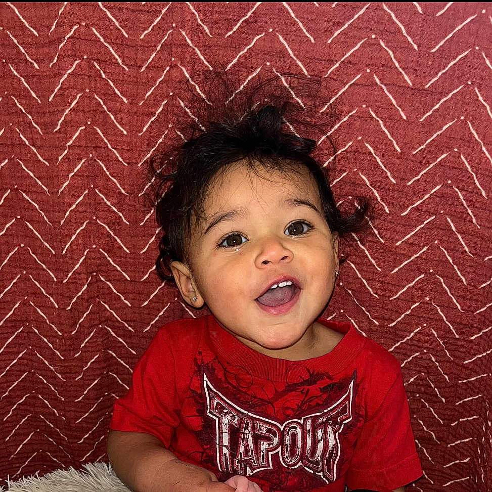 Ezaryah joined the competition — help win amazing prizes! baby, bodypart, clothing, couch, cushion, face, finger, furniture, hand, happy, head, homedecor, laughing, mouth, person, photography, portrait, smile, t_shirt, teeth