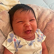 Anivia joined the competition — help win amazing prizes! baby, infant, face, tongue_out, scrunched_face, floral_clothing, onesie, blanket, soft_texture, cute, child, newborn, smiling, skin, head, arm, indoors, person, happy, portrait